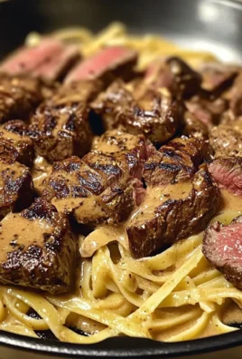 SMOKY CAJUN STEAK TIPS OVER VELVETY FETTUCCINE